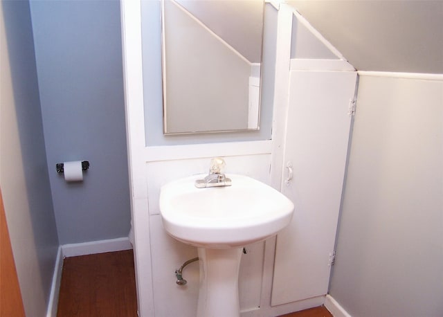 bathroom with baseboards and wood finished floors