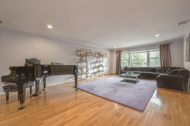 living room featuring crown molding, baseboards, visible vents, and wood-type flooring