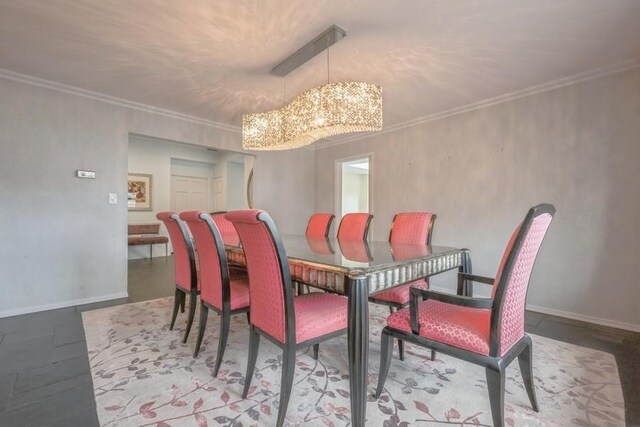 dining area featuring a notable chandelier, crown molding, and baseboards