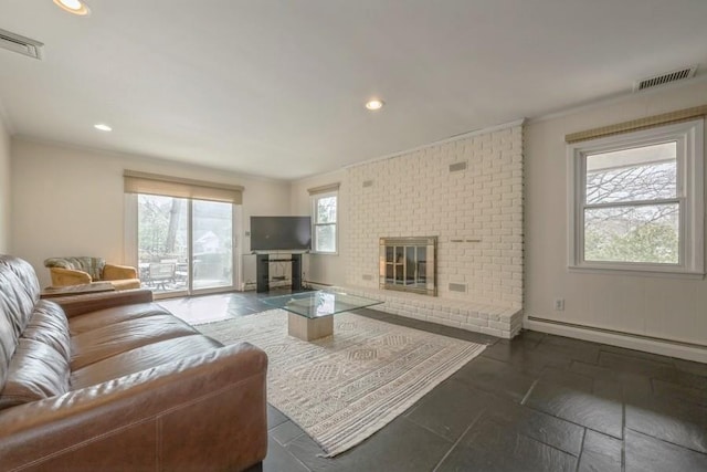 living area with visible vents, a brick fireplace, crown molding, and a baseboard radiator