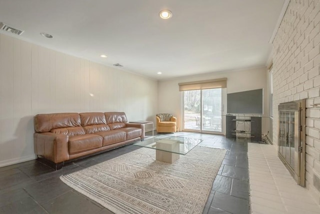 living area featuring recessed lighting, a fireplace, visible vents, and ornamental molding