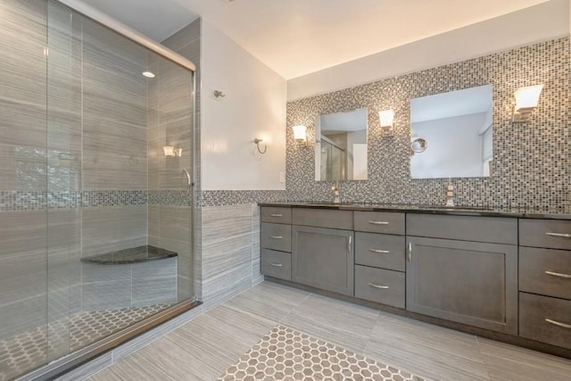 full bath featuring tile walls, a stall shower, and vanity