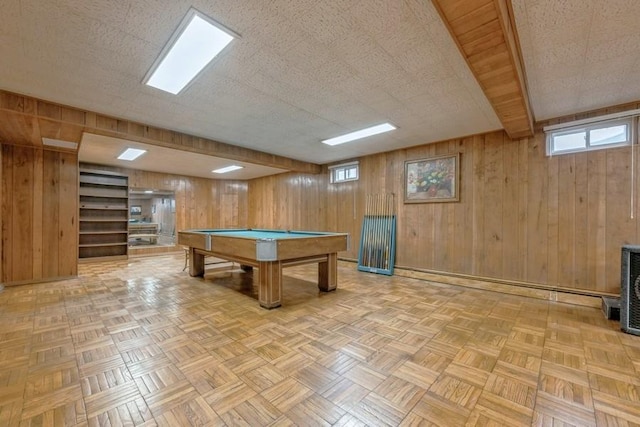 rec room with wooden walls, billiards, and a textured ceiling