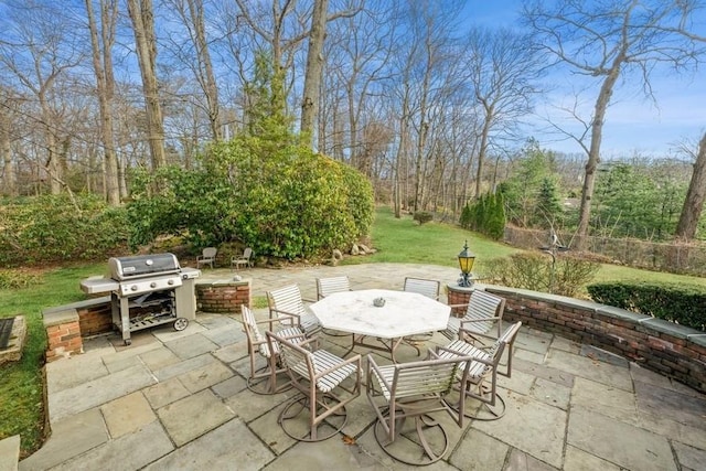 view of patio with grilling area and outdoor dining space