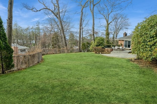 view of yard featuring a patio and fence