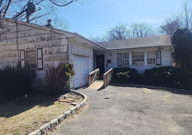 ranch-style home with an attached garage and driveway