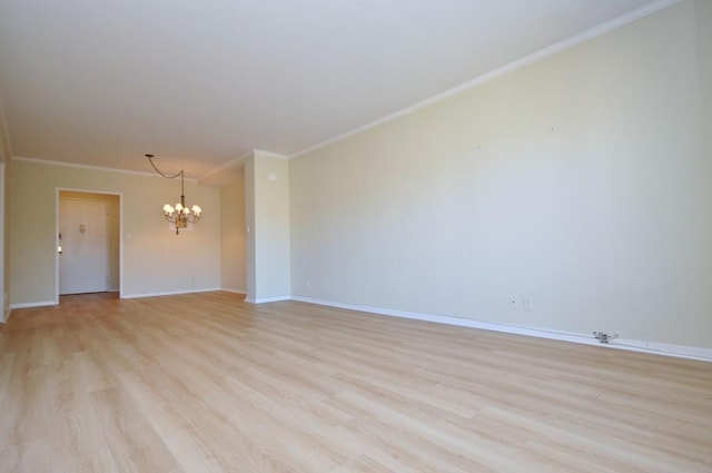 empty room with a notable chandelier, baseboards, light wood finished floors, and ornamental molding