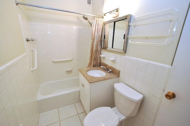 full bathroom featuring toilet, tile walls, wainscoting, and tile patterned flooring