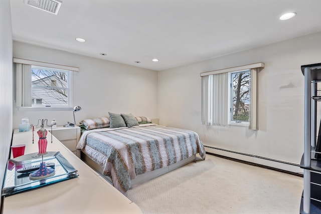 bedroom featuring recessed lighting, a baseboard heating unit, multiple windows, and visible vents