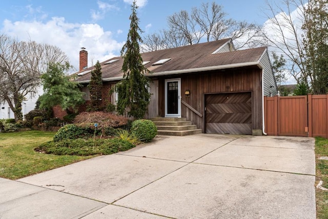 view of front facade with driveway, an attached garage, a shingled roof, entry steps, and a chimney