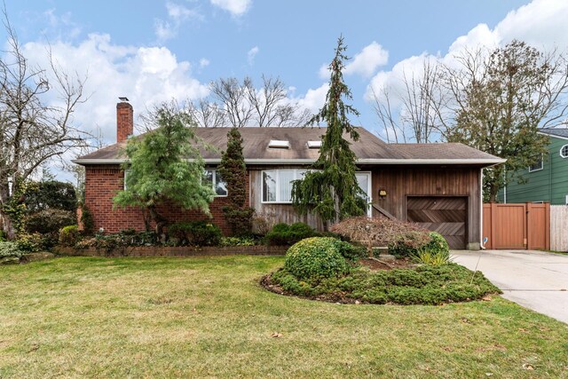 ranch-style house with a chimney, concrete driveway, a front lawn, a garage, and brick siding