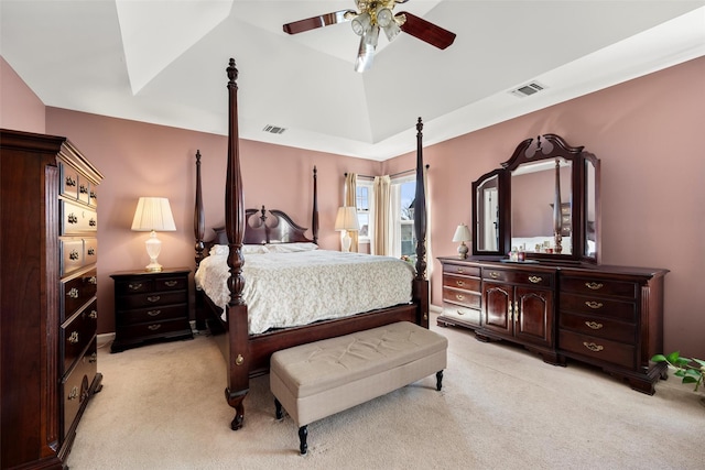 bedroom with visible vents, light colored carpet, lofted ceiling, and ceiling fan