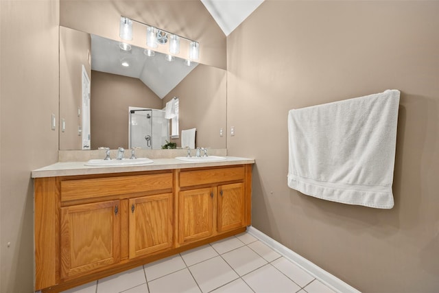 full bath with a sink, lofted ceiling, double vanity, and a shower stall