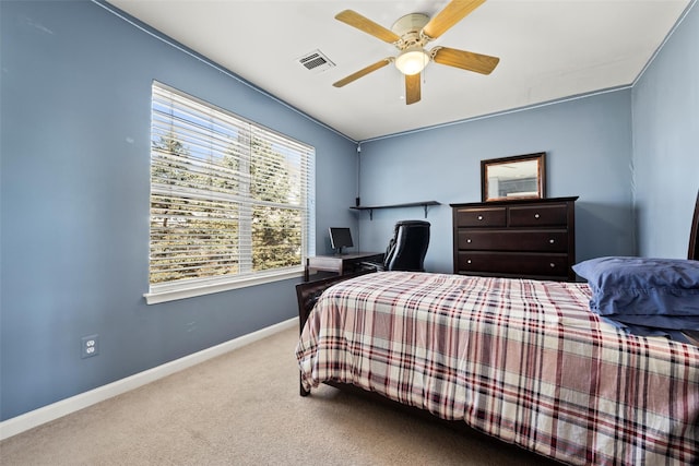 carpeted bedroom with visible vents, a ceiling fan, and baseboards