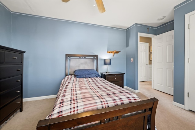 bedroom featuring baseboards, light carpet, and ceiling fan