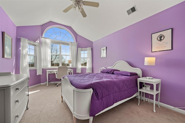 carpeted bedroom with a ceiling fan, vaulted ceiling, baseboards, and visible vents