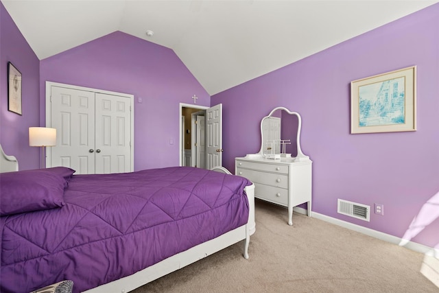 bedroom featuring visible vents, baseboards, lofted ceiling, carpet flooring, and a closet