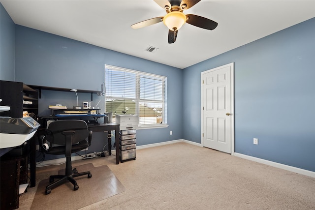 carpeted office space with visible vents, ceiling fan, and baseboards