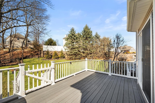 wooden terrace featuring a yard