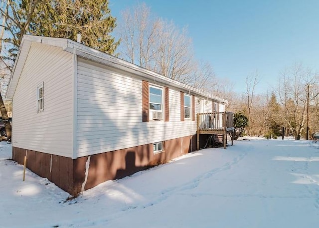 view of snowy exterior with a deck