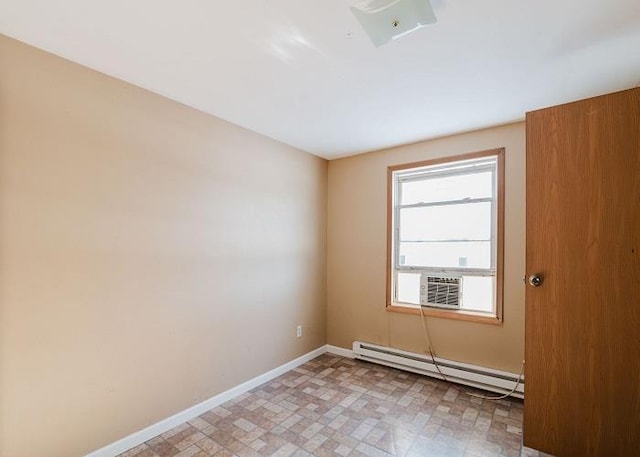 spare room with light floors, cooling unit, a baseboard heating unit, and baseboards