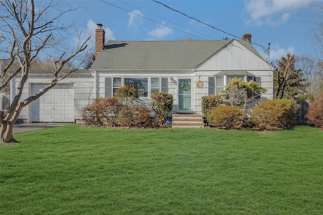 view of front of property featuring a front yard, an attached garage, roof with shingles, and a chimney