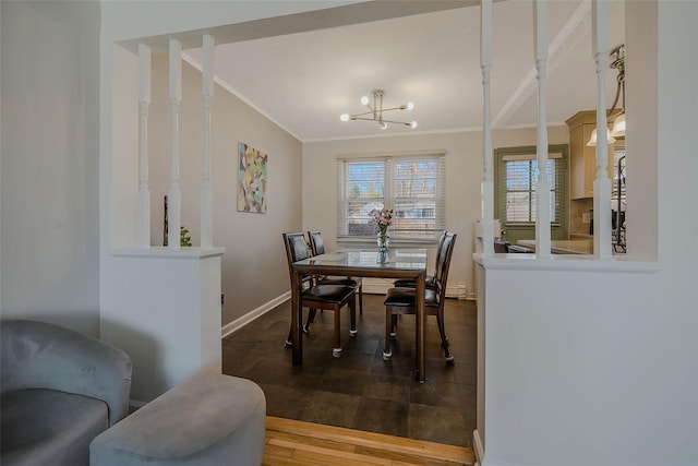 dining room with a chandelier, baseboards, wood finished floors, and crown molding