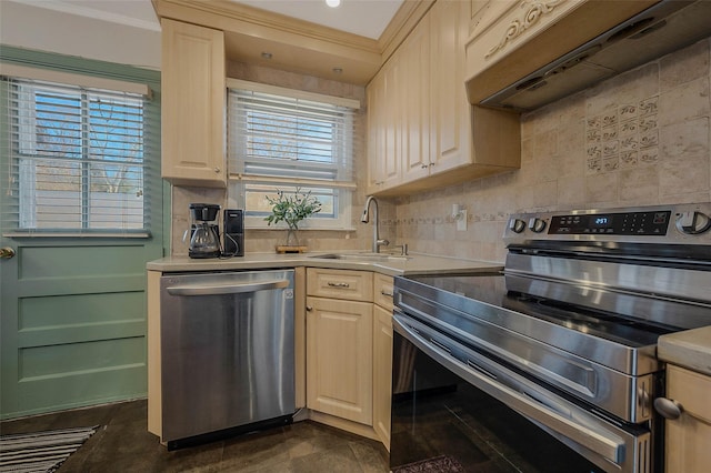 kitchen with a sink, under cabinet range hood, stainless steel appliances, light countertops, and decorative backsplash