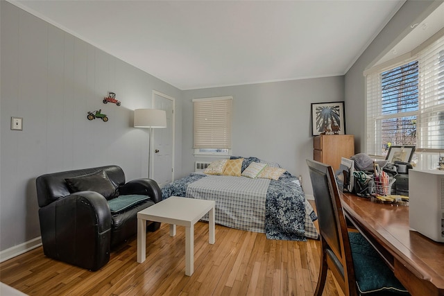 bedroom with light wood-style flooring and baseboards