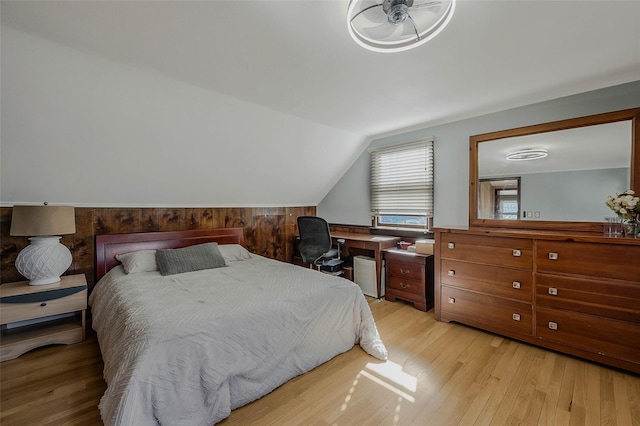 bedroom featuring lofted ceiling and light wood-style flooring