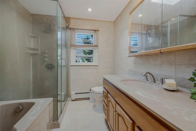 bathroom with toilet, a stall shower, tile walls, baseboard heating, and vanity