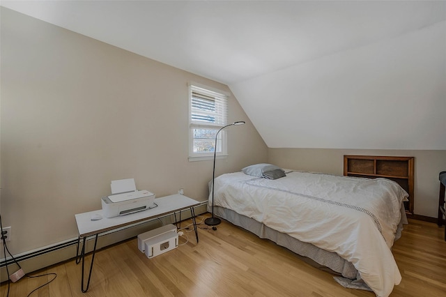 bedroom featuring light wood finished floors and vaulted ceiling