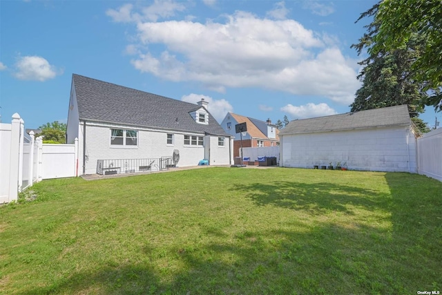 back of house with a lawn, a fenced backyard, brick siding, and a patio area