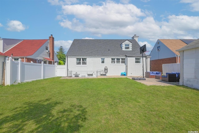 back of property with an outdoor living space, a lawn, a fenced backyard, and a patio area