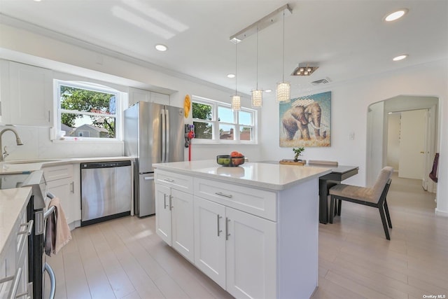 kitchen with a wealth of natural light, visible vents, appliances with stainless steel finishes, and a sink