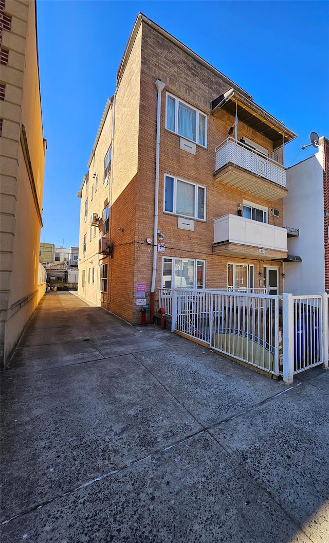 view of building exterior with fence