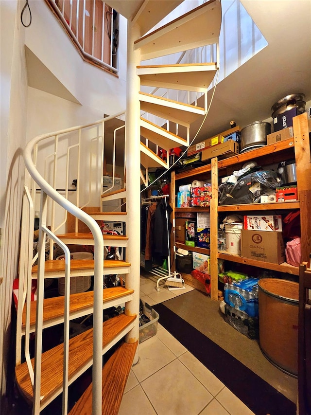 stairway featuring tile patterned flooring