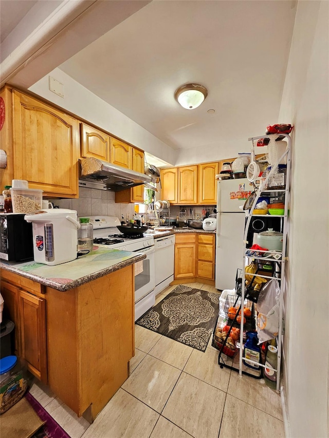 kitchen featuring white appliances, a peninsula, light tile patterned flooring, under cabinet range hood, and tasteful backsplash