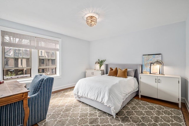 bedroom with wood finished floors and baseboards