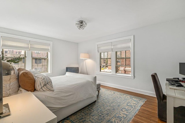 bedroom featuring wood finished floors and baseboards