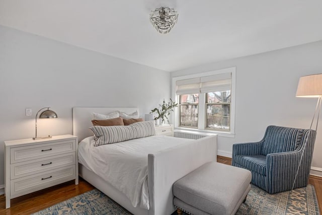 bedroom with dark wood-style floors