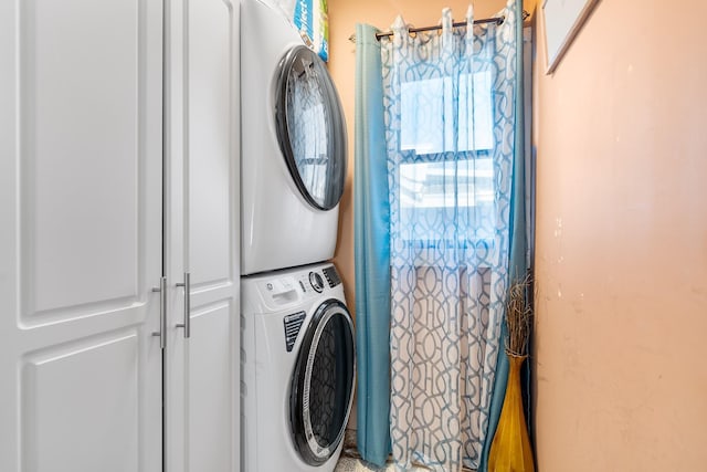 laundry area featuring laundry area and stacked washer / drying machine