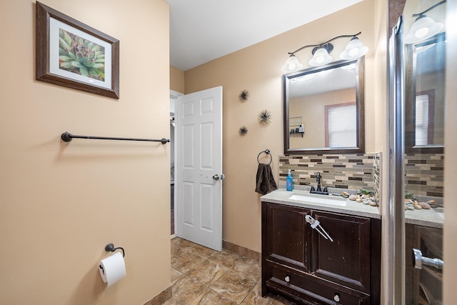 bathroom with baseboards, backsplash, and vanity