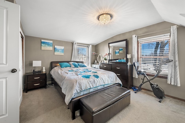 bedroom featuring baseboards, lofted ceiling, light colored carpet, and a baseboard heating unit