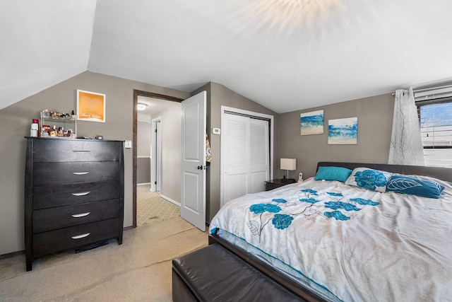 bedroom with baseboards, a closet, light carpet, and lofted ceiling