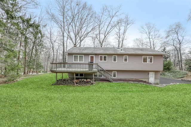 view of front of house with a deck, a front lawn, stairs, and a chimney