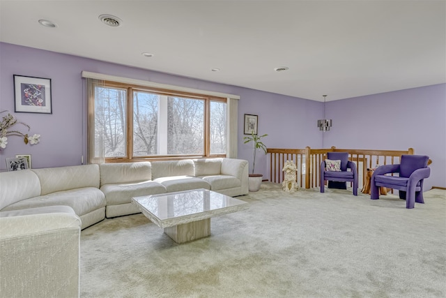 carpeted living area featuring visible vents