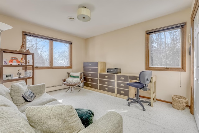 office featuring carpet flooring, baseboards, and visible vents