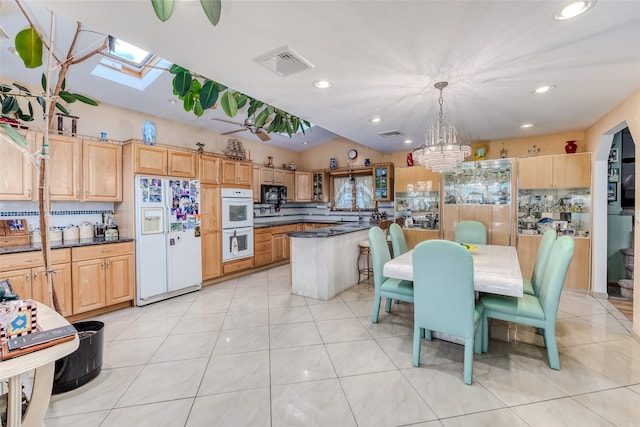 kitchen with visible vents, white appliances, backsplash, and a chandelier