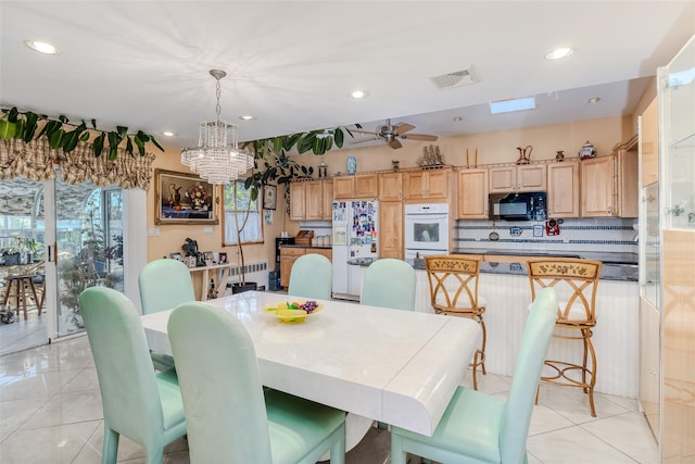 dining area with visible vents, ceiling fan, radiator heating unit, light tile patterned floors, and recessed lighting